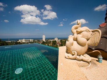 Rooftop pool area with jacuzzi and elephant fountain.