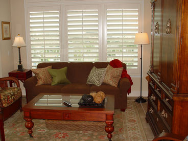 Living room with LCD television and view of bay and beach.