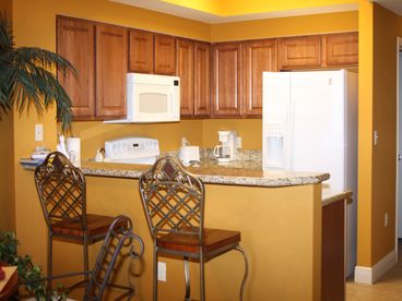 cherry cabinets, granite countertops,
dishwasher, stove, microwave, refrigerator freezer, breakfast bar w/iron
and wood bar stools