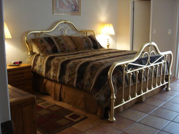 Master bedroom witih King size brass bed
