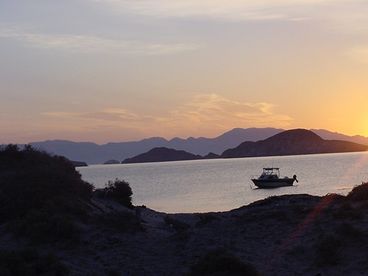 The boat in the water at sunrise