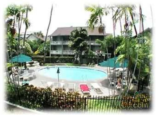 TROPICAL GROUNDS AND POOL AREA WITH TIKI TORCHES AT NIGHT VERY ROMANTIC  