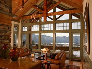 An expansive wall of windows provides incredible views of the mountains, meadow, lake and surrounding National Forest