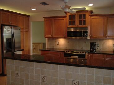 Gourmet kitchen with granite countertops and upgraded appliances.  Kitchen has all the amenities -- just make yourself at home!
