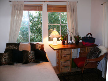 The sunlight bedroom has a queen bed, wooden blinds to keep the sunlight out in summer and large windows to let the sunshine in at all other times.