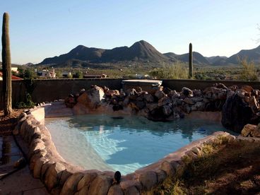 pool and spa with mountain & city views