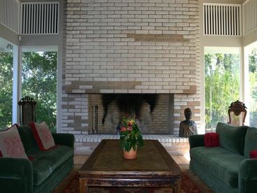 This fireplace is over 17 feet high and almost as wide. The sofas are vlevet and the coffe table is an ancient Chinese bed.