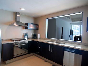 Full Amenity Kitchen: Stainless Steel Appliances, Stylish Design, & Serving Area 