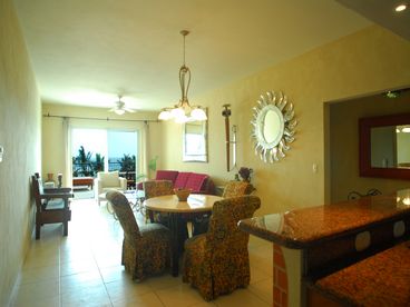 Gorgeous Spacious Living Room and Elegant Dining Area with High Ceilings, Direct Beachfront Views, and Exquisite Custom Rustic Design