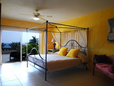 Gorgeous Beachfront Master Bedroom with Canopy Bed, Sitting Area, Large Closet Space, Direct Beach Terrace Access, and Unique Design