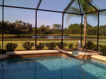 Beautiful view of lake and forest preserve beyond pool