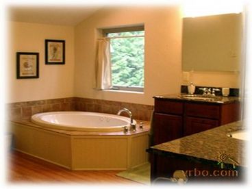 Master Bathroom with jetted tub, two sink areas and separate shower