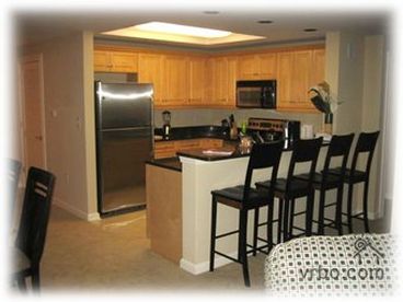 Full kitchen and dining room with stainless steel appliances.