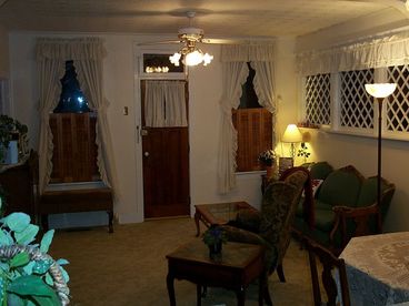 COZY LIVING ROOM WITH EXPANSIVE DIAMOND PANED WINDOWS AND A WOODBURNING STOVE.CABLE TV AND A SELECTION OF DVD\\\\\\\\\\\\\\\'s FOR RELAXING.