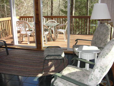 Rest and relax on the comfortable chairs of this beautiful sunroom.