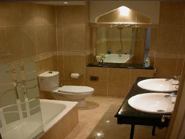 Family bathroom with his & her sinks, bath shower, WC & bidet.