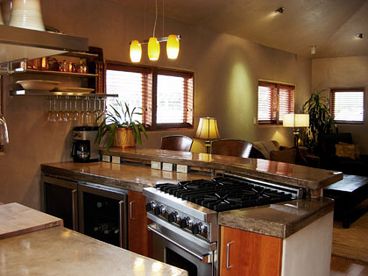 Full Gourmet Kitchen stocked with dinnerware and cooking utensils. 