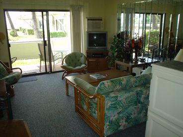 Living room lookng towards sliding glass door to the lanai and oceanview