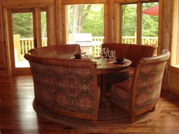 Dining area has unique dining benches with a lazy susan in the center of the table