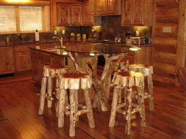 Kitchen has top of the line Monogram appliances two dishwashers and unique branch bistro table with cedar bar stools