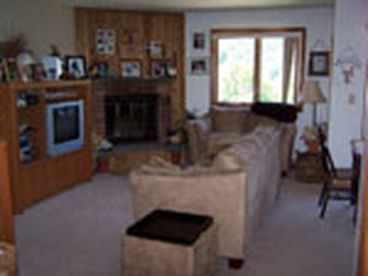Cozy living area with woodburning fireplace.