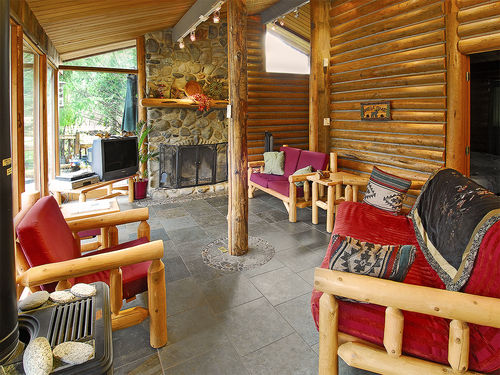 Open and airy living room with rock fireplace and heated floors.