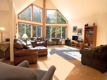 Cozy living room with hard wood floors and lots of natural light and views.