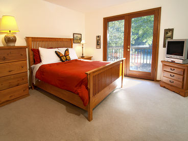 Spacious master bedroom has double doors that lead to deck and amazing river views!