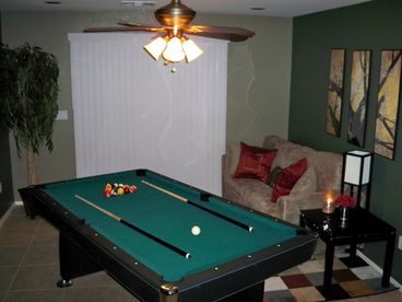 Gameroom includes a pooltable, and a flat panel T.V mounted on the wall. The sofa pulls out into a queen size bed