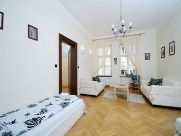 Living room with SAT tv, sofa and 2 single beds