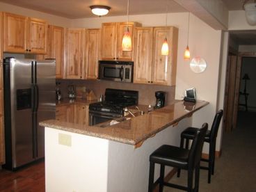 The kitchen is fully equipped with all the necessary tools to cook and feed a large family.  Beautiful wood floors and a breakfast bar will make you feel right at home.