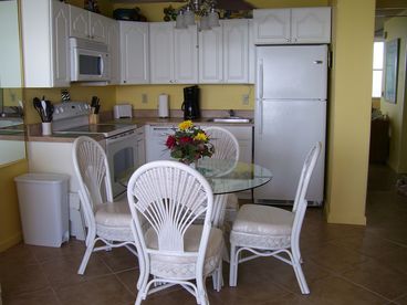 Kitchen with full size dishwasher, large refrigerator and glass top cook stove.