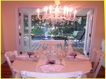 Dining Room with Open French Doors
and water garden with fountain beyond