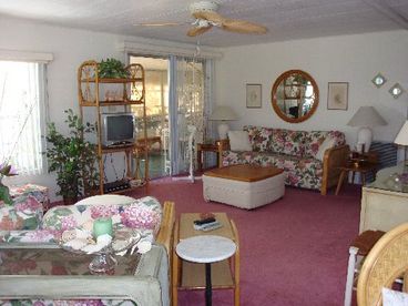 Spacious and bright.  Windows have louvered awnings for light and privacy.  Clean comfortable furnishings include recliner, sofa bed and loveseat.