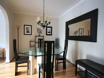 Modern dining room for 6, with high ceilings, crown moldings, hardwood floors.