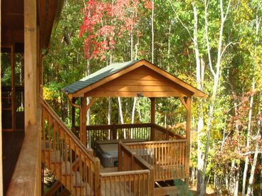 8 person hot tub sunken on it s own covered deck with great views