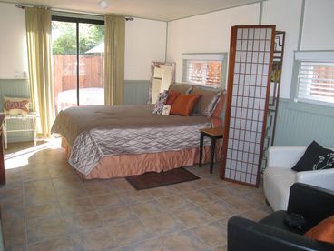 A lovely queen bed leads to sliding glass doors which open to your own private fenced in patio with hot tub