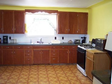 Huge Country Kitchen with microwave and coffee maker.