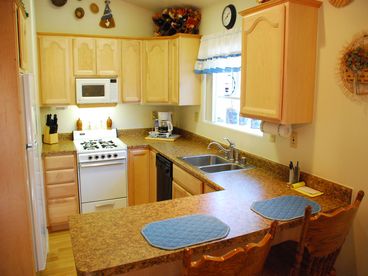 Complete with microwave, stove, oven, dishwasher, garbage disposal, double sink, coffee maker, cooking utensils, spices, breakfast bar and Internet connection.