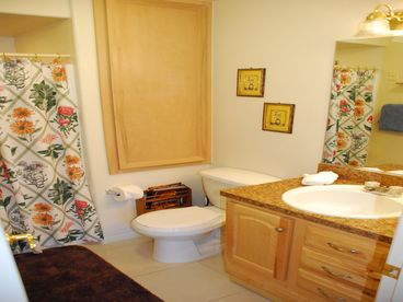 A comfortable bathroom, equipped with hair-dyer full mirror and 2-doors; one that leads to hallway and the other leads to bedroom for privacy.