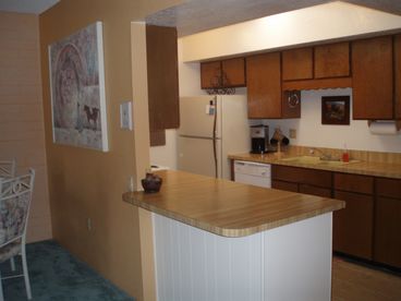 Kitchen opens to living room and dining area.