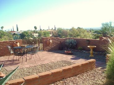 Fully bricked back yard patio overlooks arroyo and has excellent mountain views, sun rises over the Santa Ritas.