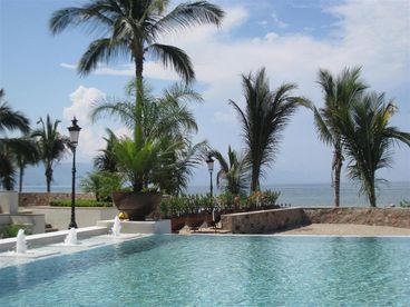 Portion of Large Infinity Pool Next to Beach and Tropical Grounds