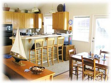 Kitchen & dining room w/ door to deck