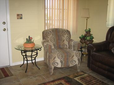 Living room has a comfortable chair. Double reclining leather sofa, LCD TV, DVD, Cable, Secretary with WiFi connection.
