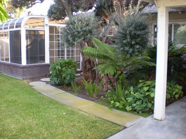 Enjoy the lush backyard with enclosed hot tub.