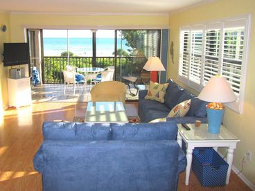 Bright and sunny living room, with new furniture, large side windows, and stunning direct ocean view