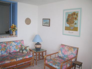 Livingroom with sofa, chair, television and gorgeous view of Banderas Bay