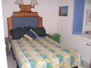 Bedroom with end tables, and lovely view of Banderas Bay. Plenty of storage area and drawers.