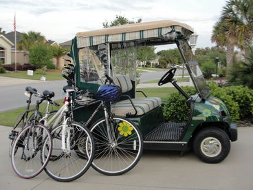 Electric golf cart and 3 nearly-new bicycles.